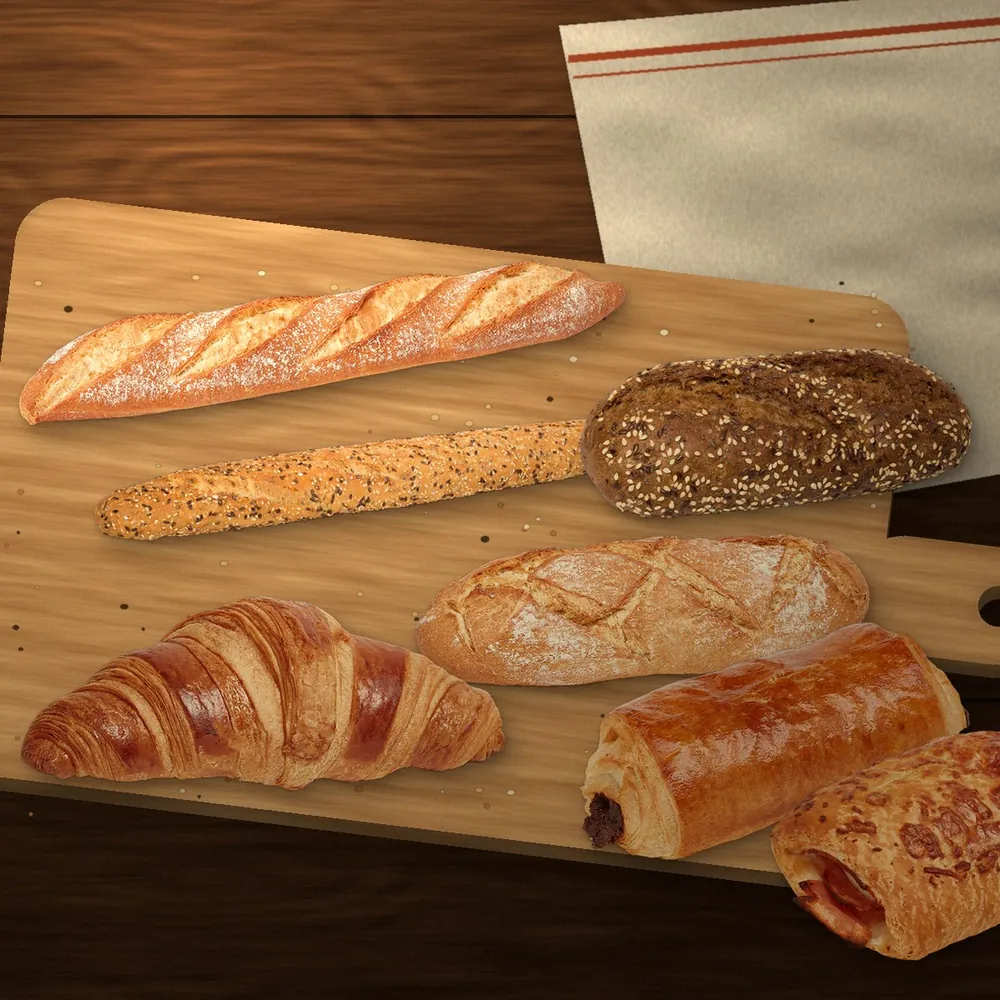 Barras, pan de centeno, croissant y napolitanas recién horneados sobre una tabla de madera